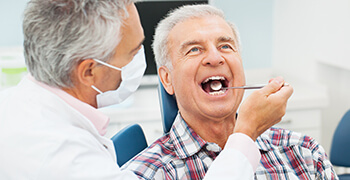 man
    getting check for oral cancer