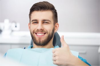 Man smiling with thumb’s up