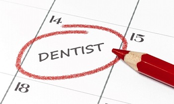 A calendar with “DENTIST” circled in red