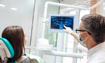 dentist showing a patient their dental X-rays
