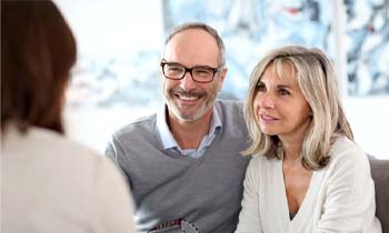 man and woman at dental implant consultation